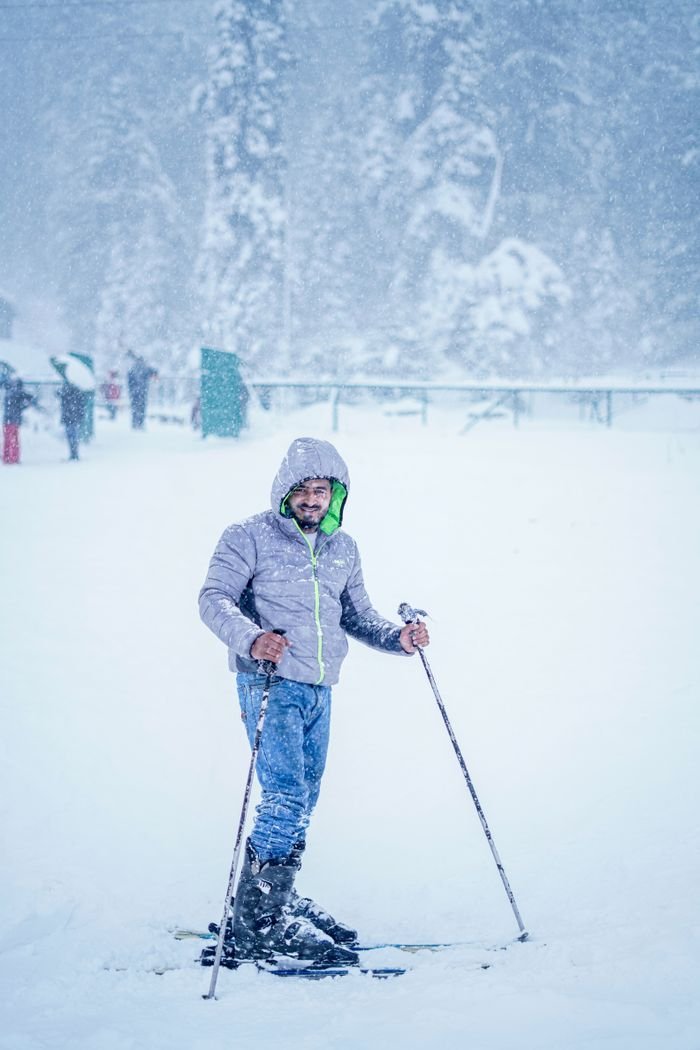 about-06 Man skiing in snowy Gulmarg, showcasing winter sports adventure in a picturesque setting.